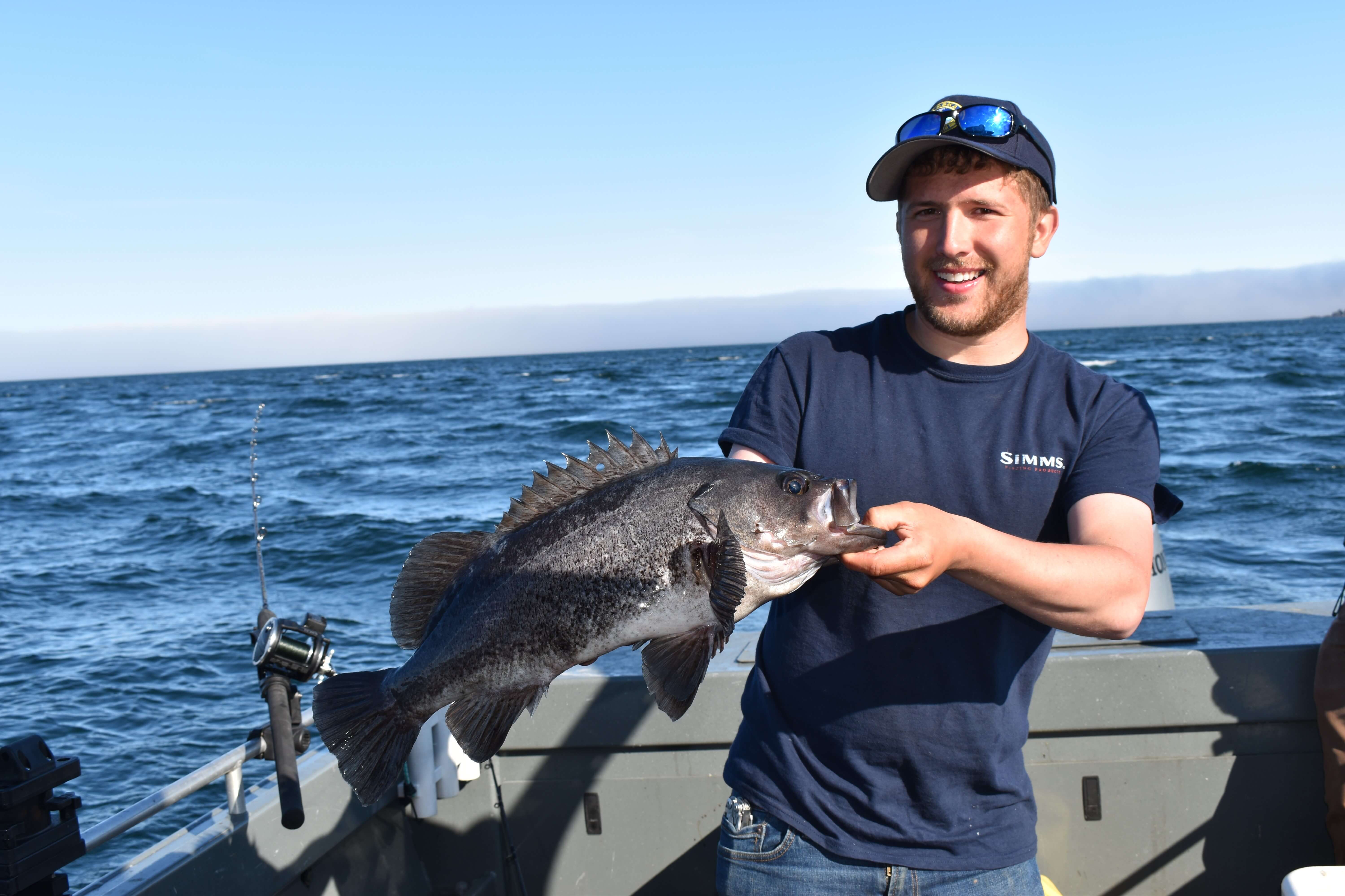 person holding a black rockfish