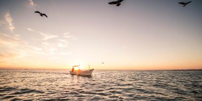 small fishing vessel at sunset